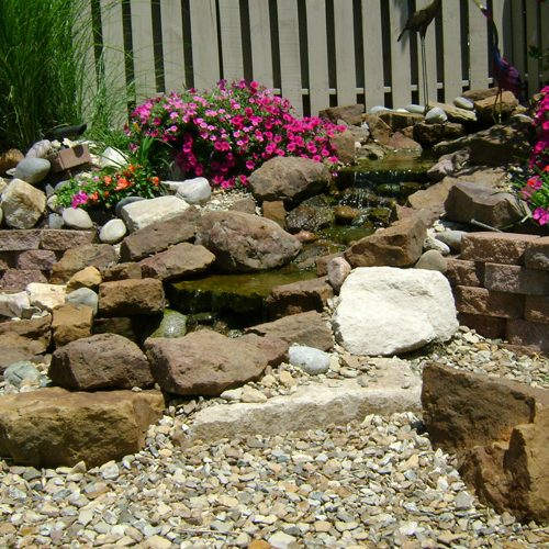 Backyard landscaping: water stream and pond, horticulture, natural stone