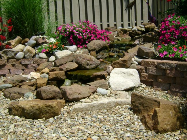 Backyard landscaping: water stream and pond, horticulture, natural stone